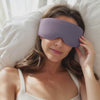 Settling the Sleep Bead mask over her eyes in a sunlit bedroom